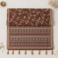 Brown saree with open pallu on off-white linen