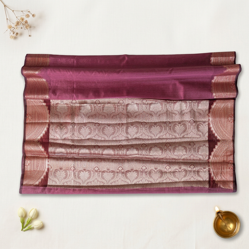 Saree edit with off-white linen, brass diya and delicate floral accents