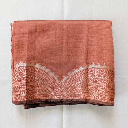 Saree on an off-white linen background in a square composition